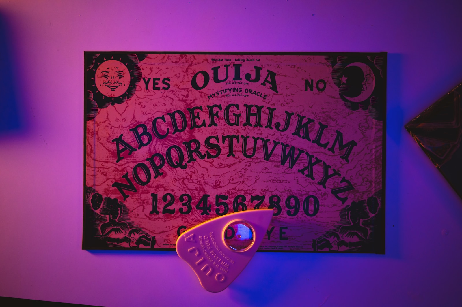 a purple lit room with a sign and a pair of scissors