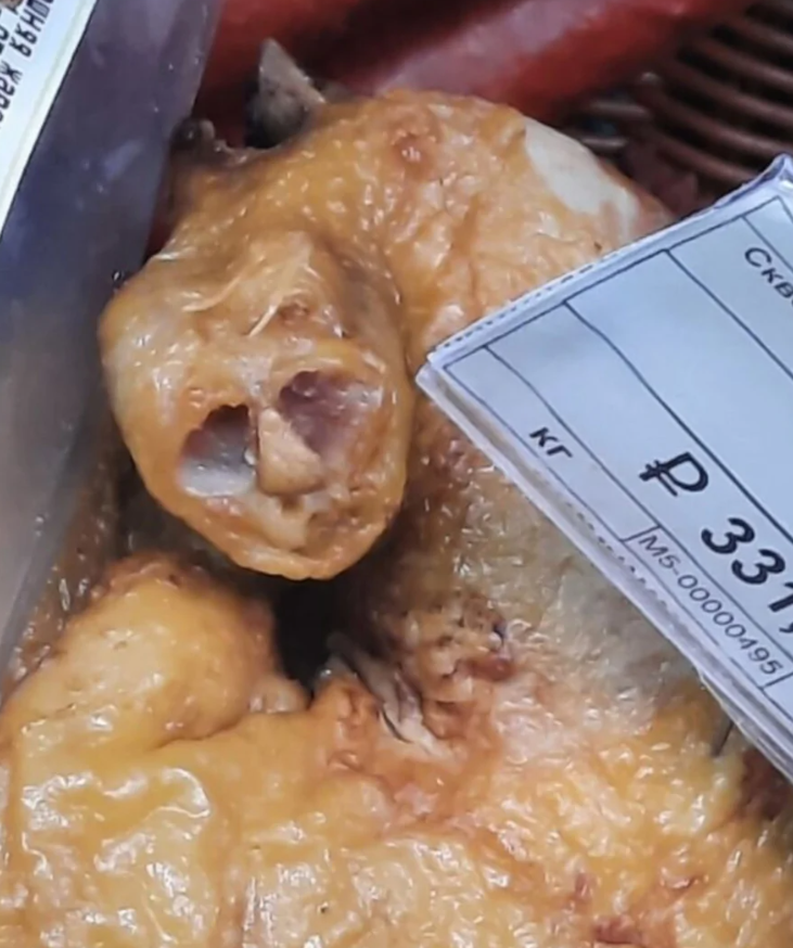 Pečené kuracie mäso na predaj s cenovkou, detailný záber na textúru kože.