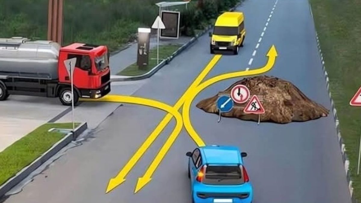 Cesta s prekážkou: auto a dodávka obchádzajú výkop, kamión v bočnej ulici čaká na prejazd.