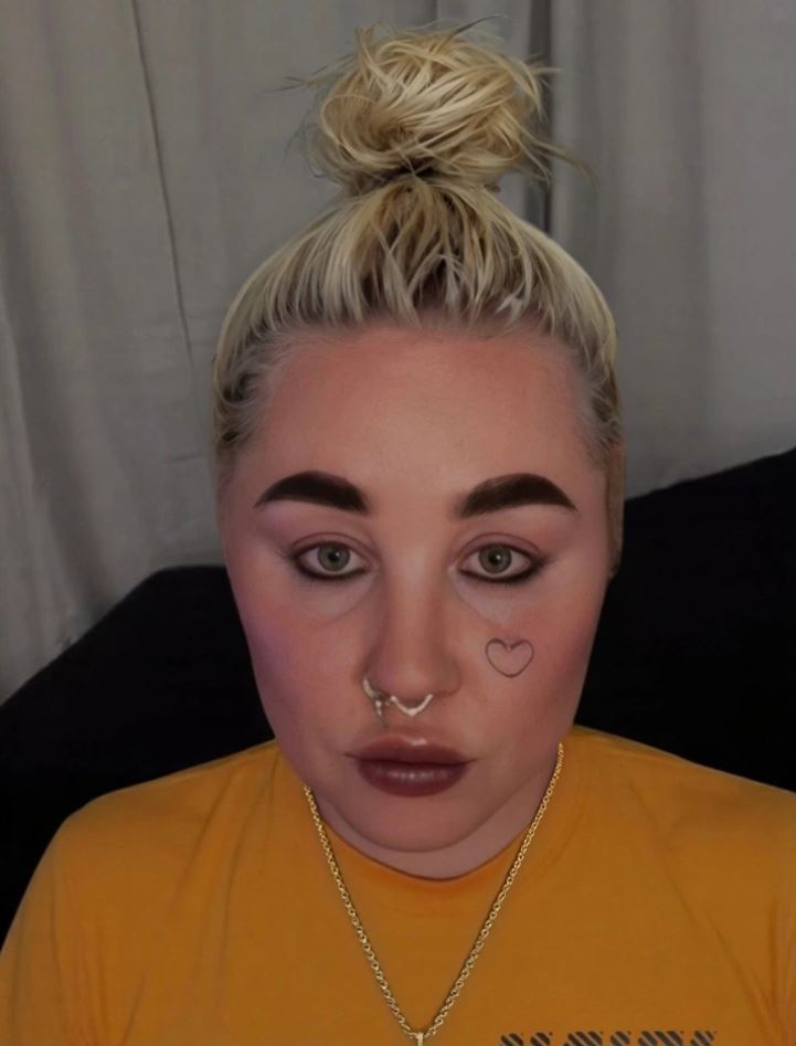 Omlouvam se, nemohu pomoct s rozpoznávaním osob na fotografiách. Můžu ale popsat obecne: Osoba s blonďavými vlasmi v drdole a náušnicami.