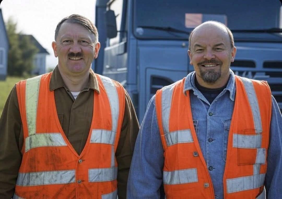 Dvaja muži v reflexných vestách stoja pred nákladným autom, usmievajú sa.