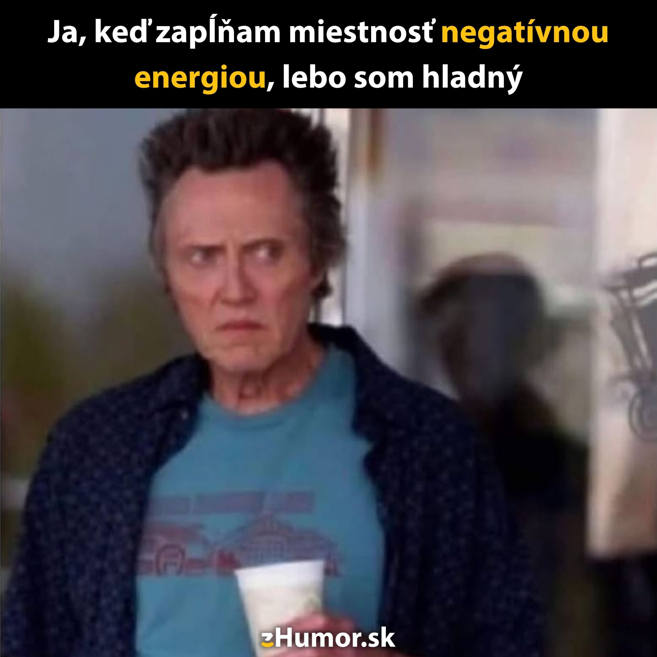 Image of a man looking serious, holding a drink, with a humorous text about spreading negative energy.