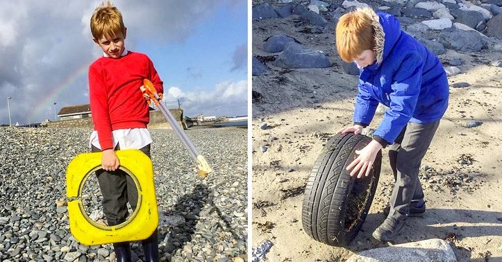Chlapec zbiera odpadky na kamennej pláži, pomáha chrániť životné prostredie.