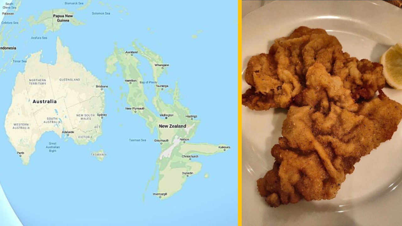 Mapa Austrálie a Nového Zélandu vedľa vyprážaného rezňa na tanieri s citrónom.