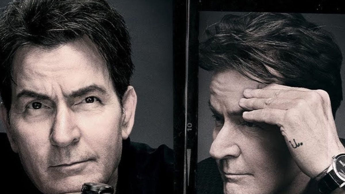 Neznámy muž v čiernobielom portréte pozerá zamyslene do diaľky, ruka položená na čele.