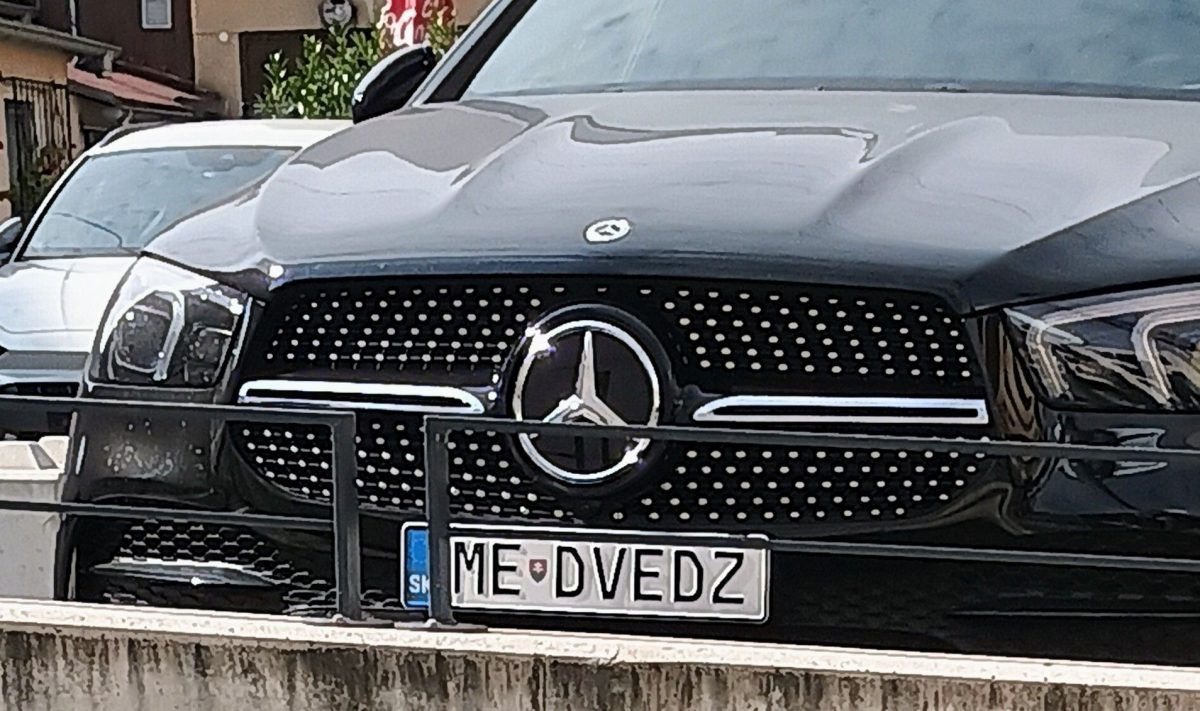 Čierny Mercedes so slovenskou poznávacou značkou ME-DVEDZ zaparkovaný pred domom.