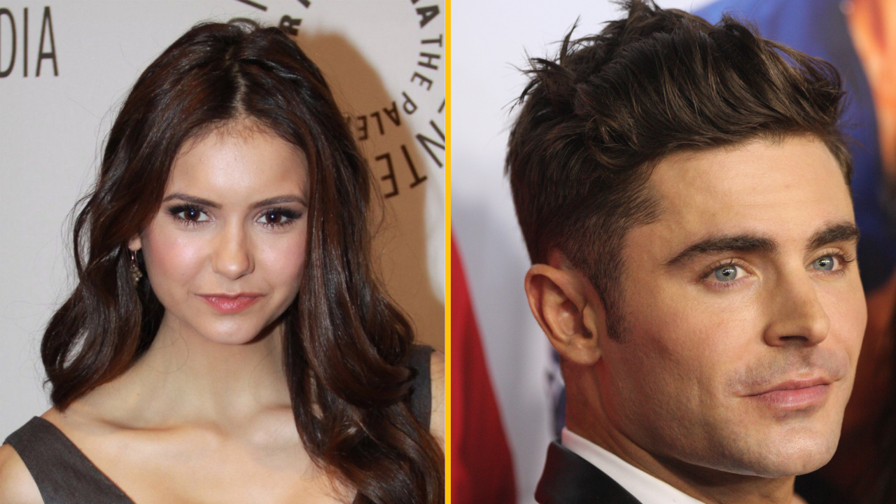 Dvě neidentifikované osoby pózujú na červenom koberci, formálne oblečenie, úsmevy.