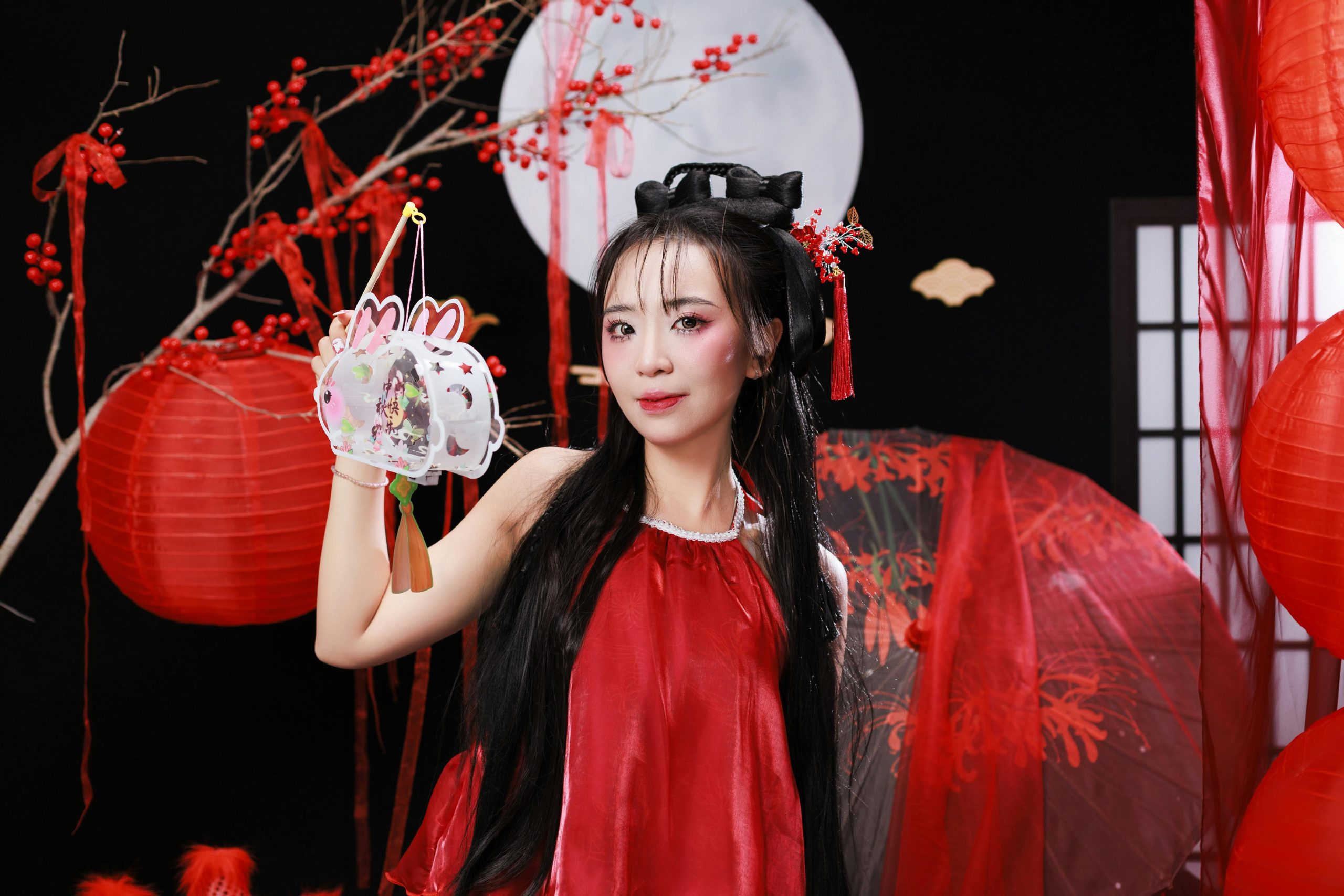 Žena v červenom kimone s lampiónom na festivalovej pozadí plnom tradičných dekorácií.
