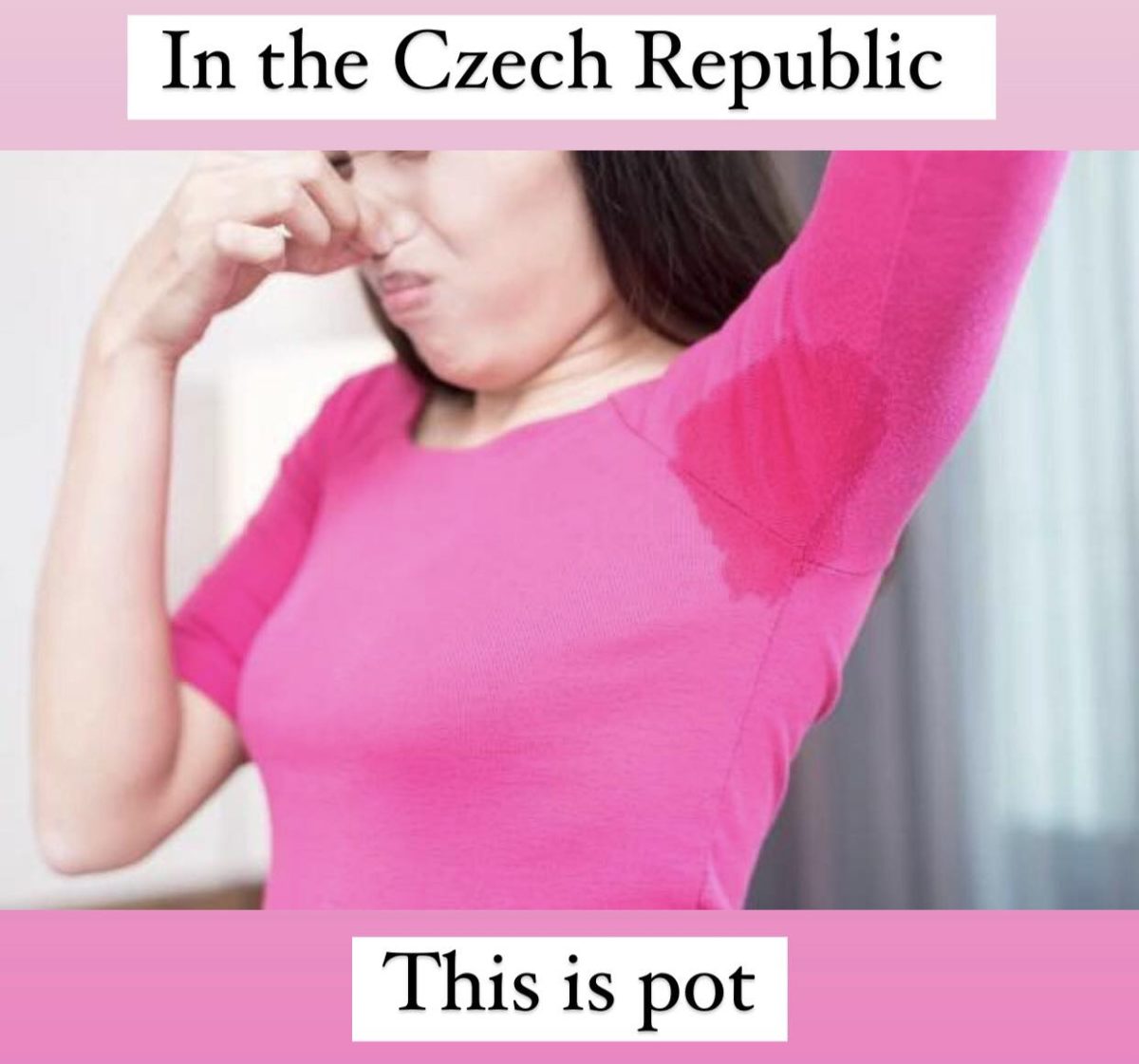 Žena v ružovom tričku s prepoteným podpazuším si drží nos kvôli zápachu.