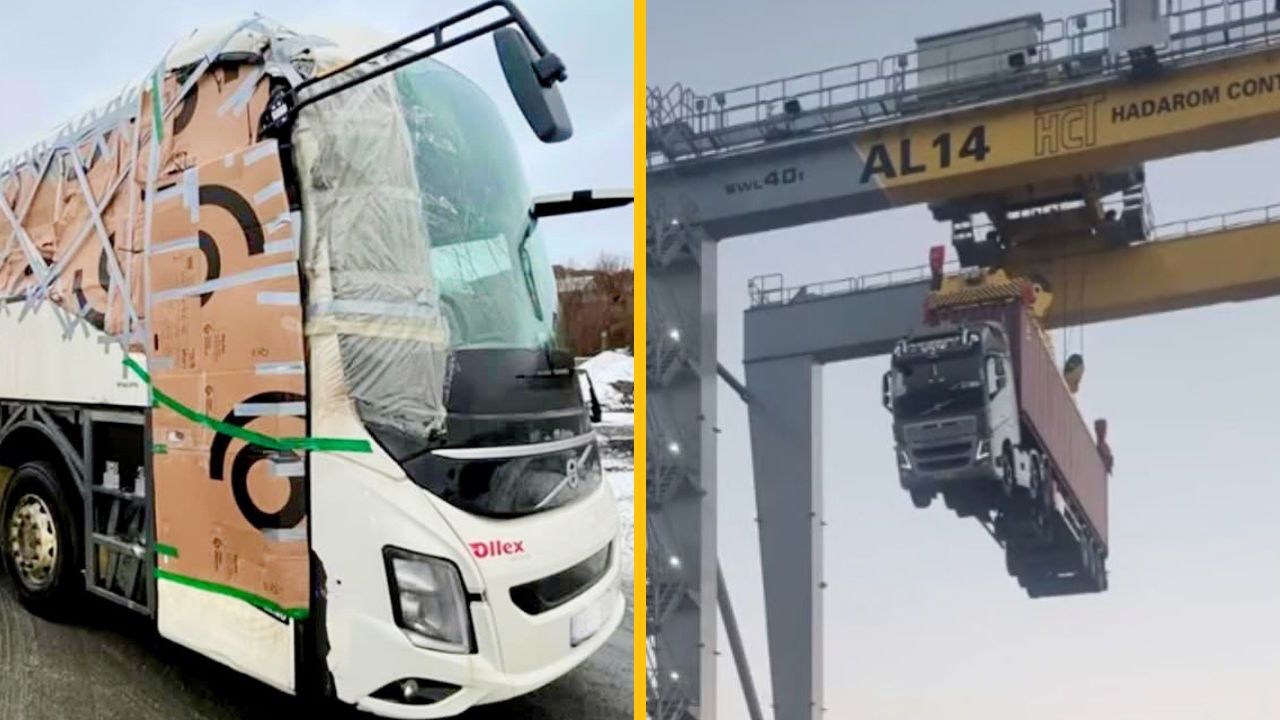 Kamión so zabalenou prednou časťou vedľa ďalšieho zdvihnutého žeriavom na nakladacej rampe.