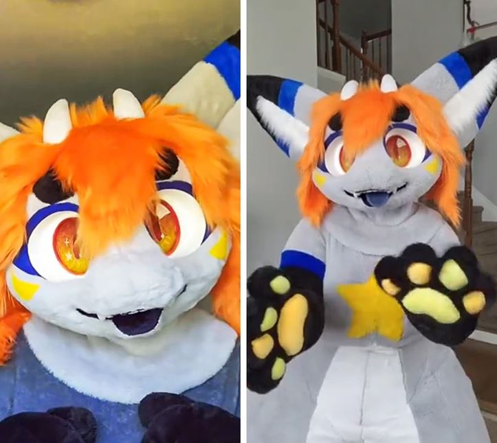 Animovaný postava v oranžovo-modrom kostýme s veľkými očami a žltou hviezdou na bruchu.