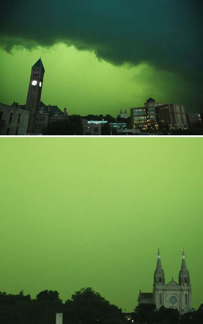 Zeleňou zafarbená obloha nad mestom s vežami a budovami, predzvesť blížiacej sa búrky.