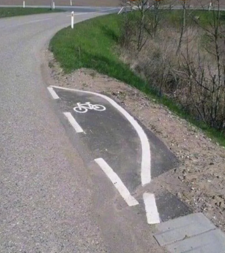Dvojitá cyklocesta končiaca v príkope vedľa cesty, neštandardné označenie pre cyklistov.