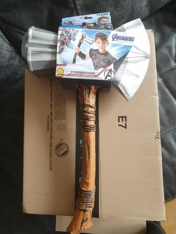 Detská hračka Thorovej sekery Stormbreaker na kartónovej krabici, Avengers Endgame motív.