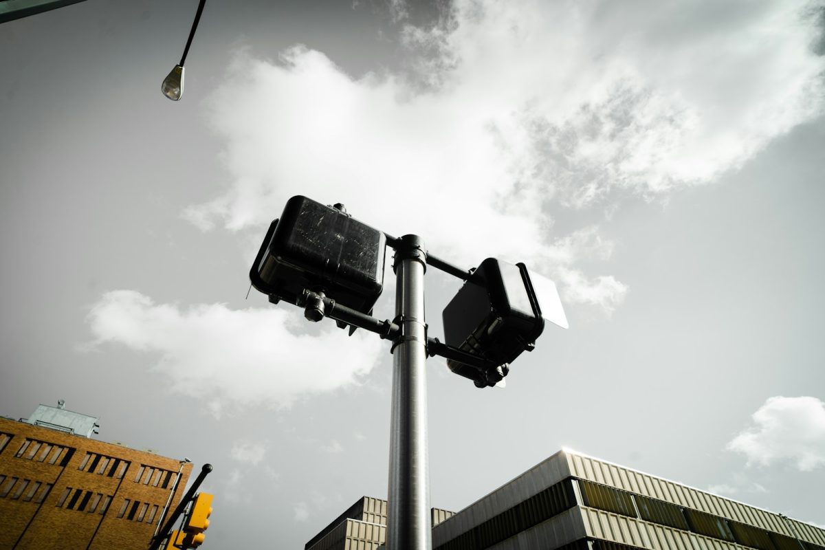 black and gray street light under gray cloudy sky during daytime