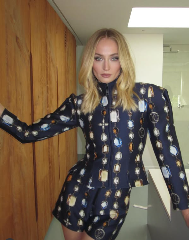 Módna fotografia ženy v štýlovom modrom oblečení s geometrickými vzormi na drevenom pozadí.