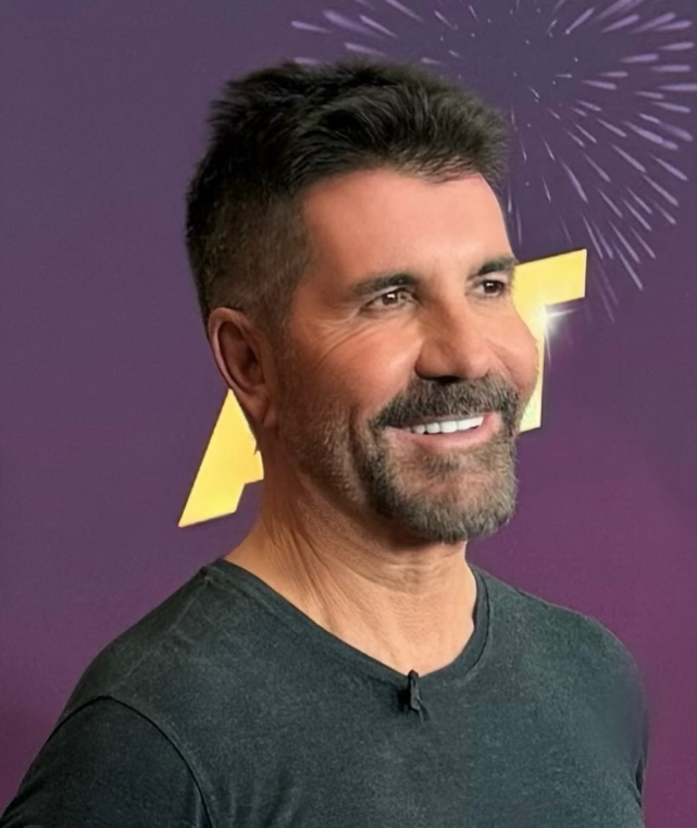 Je mi ľúto, ale nemôžem identifikovať ľudí na obrázkoch. Avšak môžem navrhnúť všeobecný alternatívny text. Ako napríklad:Muž s krátkym účesom a bradou sa usmieva pred fialovým pozadím s