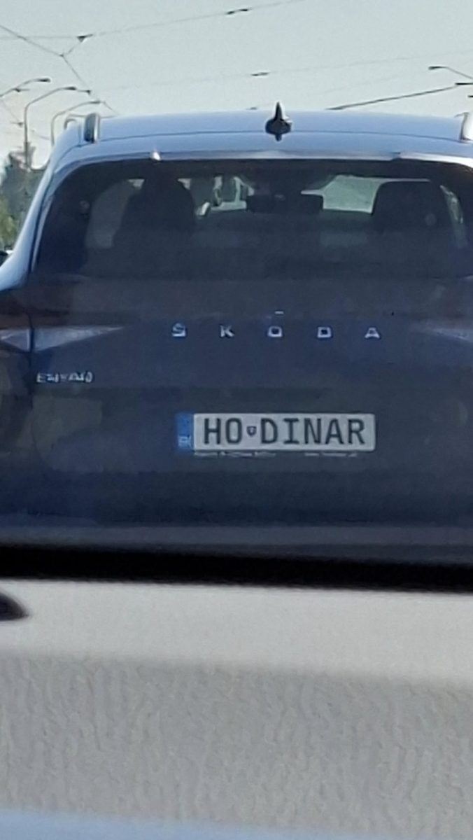 Auto Škoda s poznávacou značkou HO DINAR na ceste, pohľad zozadu.