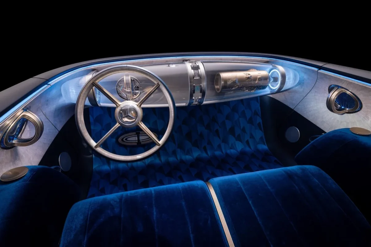 Interiér futuristického auta s modrými sedadlami a elegantným volantom.