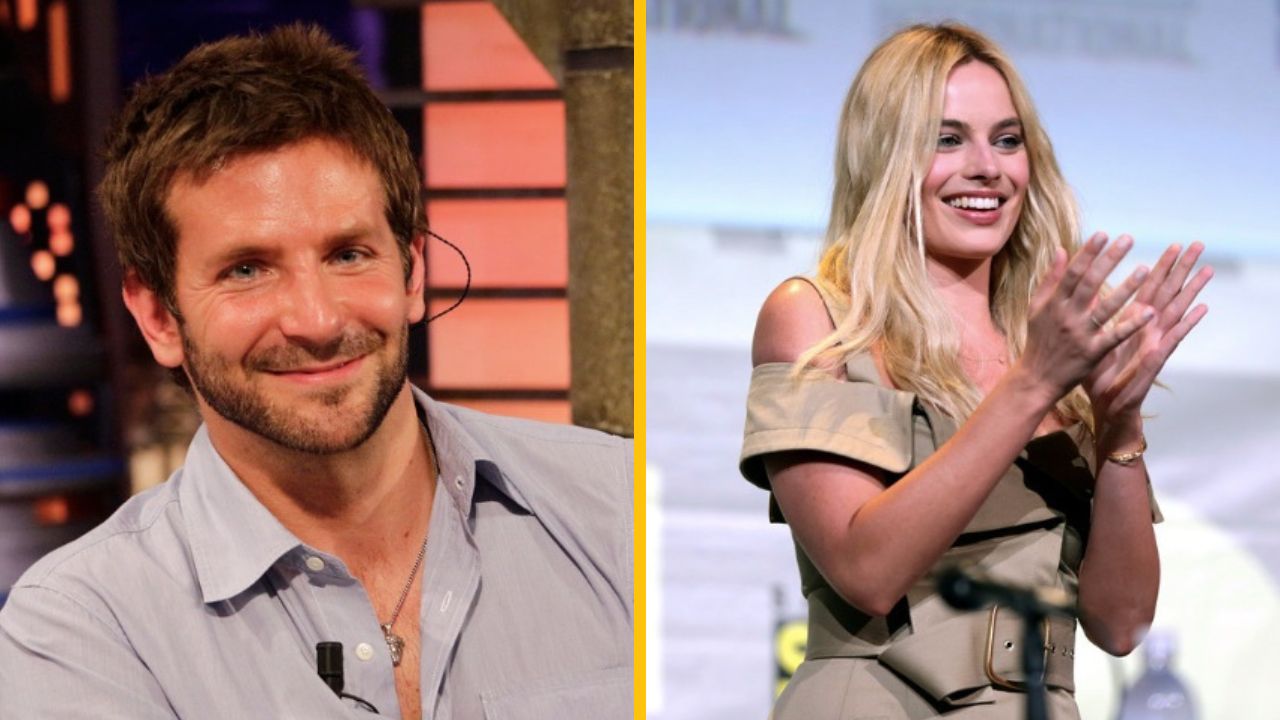 Dve osoby na pódiu, muž s úsmevom a žena tlieskajúca, tmavo-blond vlasy, formálne oblečenie.