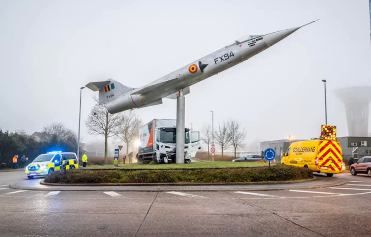 Kamión narazil do lietadla v kruhovom objazde, s policajnými autami a dodávkami na mieste nehody.