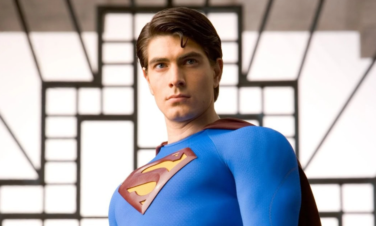 Superhrdina v modrom kostýme s červeným plášťom a symbolom S na hrudi stojí odhodlane v modernom prostredí.