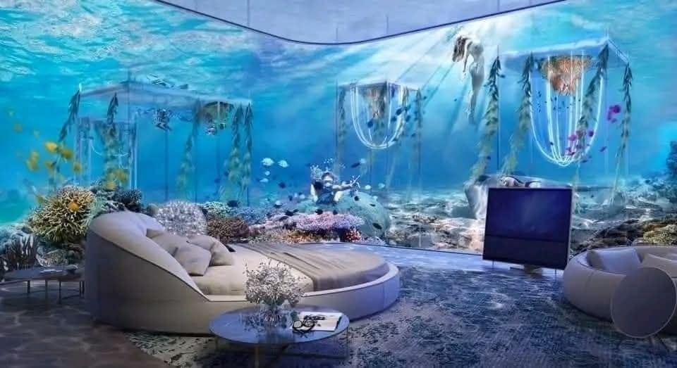 Podvodný interiér: Luxusná spálňa s akváriovým dizajnom, obklopená morskými koralmi a rybami pre pocit oceánskeho pokoja.