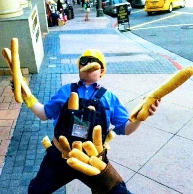 Stavebný robotník so salámou zápasí s bagetami na rušnej ulici.