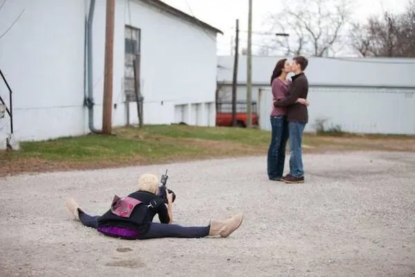 Fotografka na zemi fotí pár pri objatí na otvorenom priestranstve.