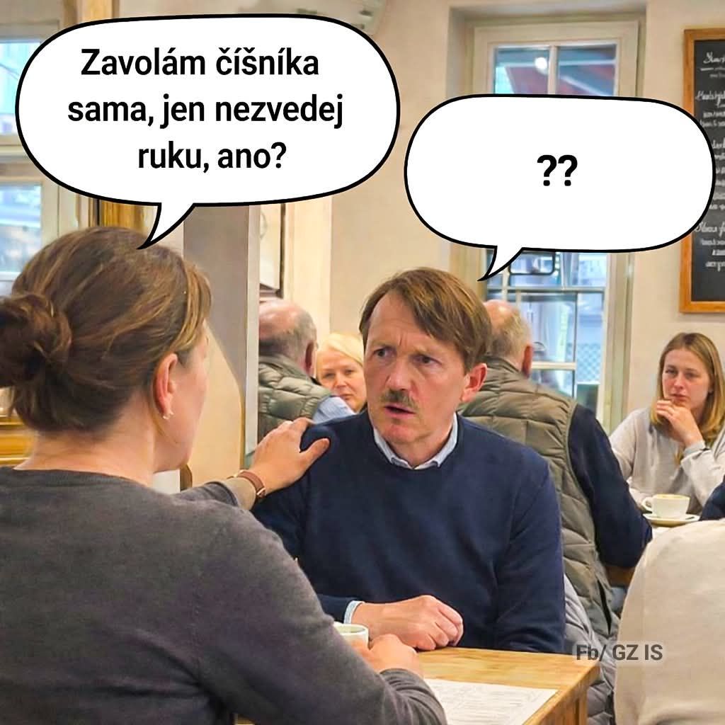Žena s pokojom utíšuje muža v reštaurácii, obaja sú sústredení na rozhovor.