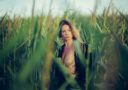 woman standing on corn field at daytime